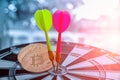 GreenÃ¢â¬â¹ andÃ¢â¬â¹ RedÃ¢â¬â¹ DastÃ¢â¬â¹ arrow hittingÃ¢â¬â¹ near bitcoinÃ¢â¬â¹ onÃ¢â¬â¹ dartboardÃ¢â¬â¹ Royalty Free Stock Photo